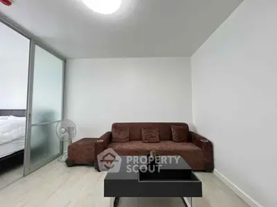 Modern living room with brown sofa and sleek black coffee table
