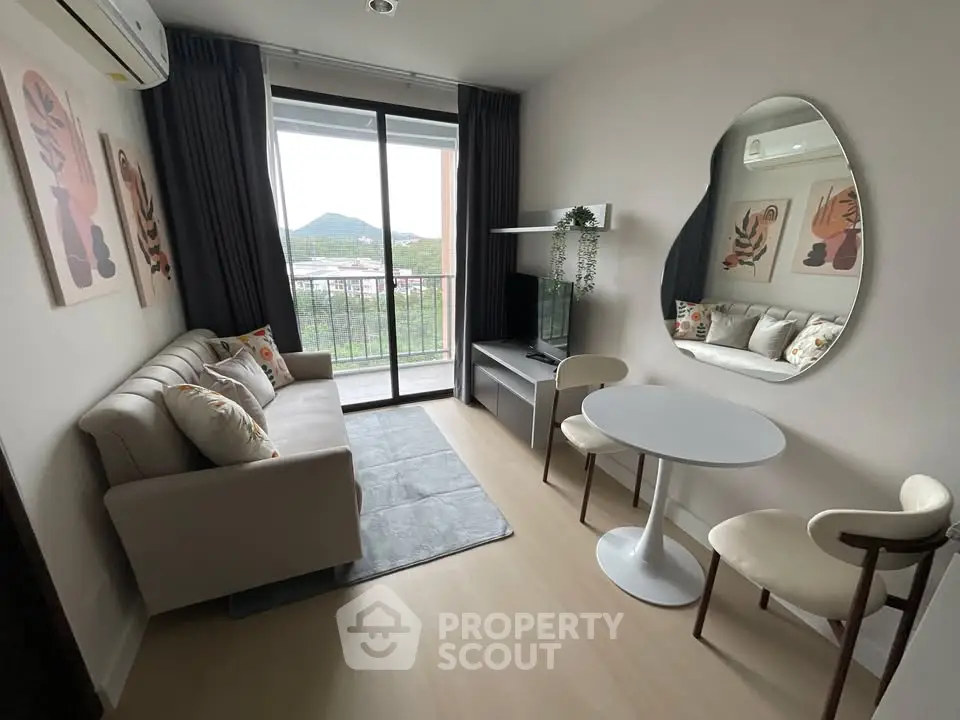 Chic modern living room with balcony view, stylish decor, and cozy seating area.