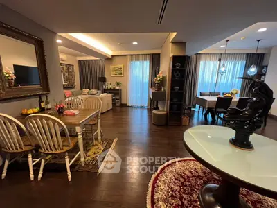 Spacious and elegantly furnished open-plan living area with classic dining set, plush seating, and tasteful decor, perfect for entertaining and comfortable living.