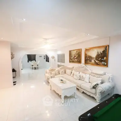 Luxurious living room with elegant white furniture and stylish decor, perfect for sophisticated gatherings.