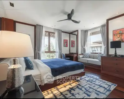 Luxurious bedroom with modern decor and large windows offering natural light.