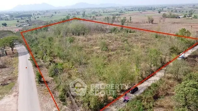 Expansive plot of land with clear boundaries, ideal for development in a scenic rural setting.