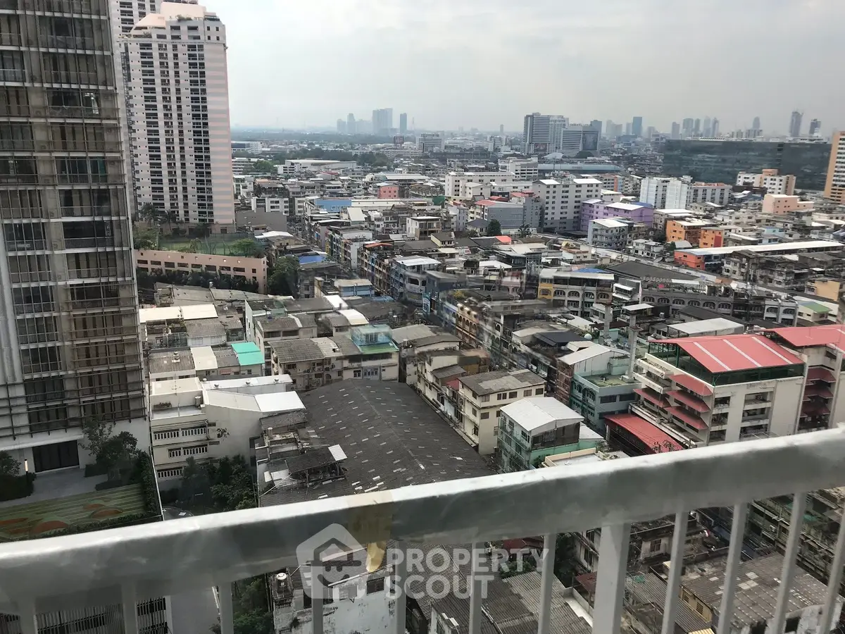 Stunning urban cityscape view from a high-rise balcony, showcasing diverse architecture and skyline.