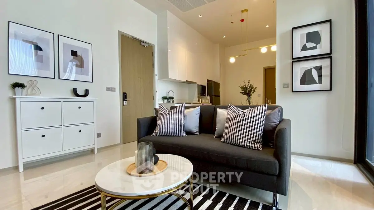 Modern living room with stylish decor and open kitchen layout in a contemporary apartment.