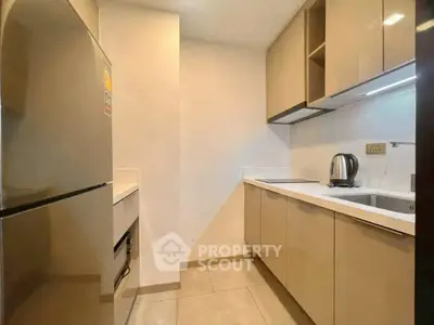 Modern kitchen with sleek cabinetry and stainless steel appliances in a compact layout.