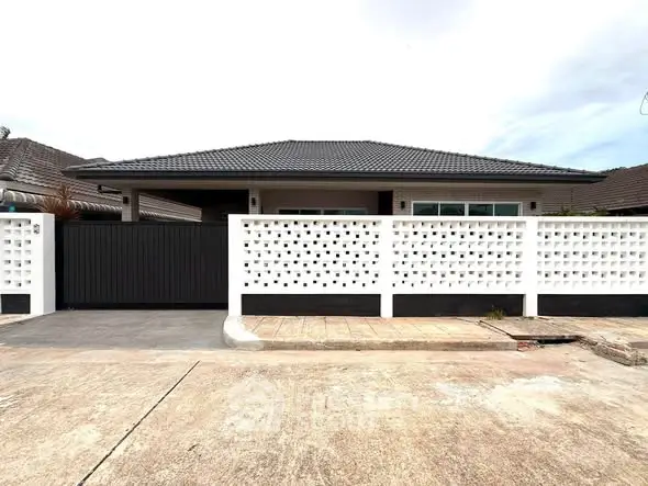 Modern single-story house with stylish facade and secure gated entrance.