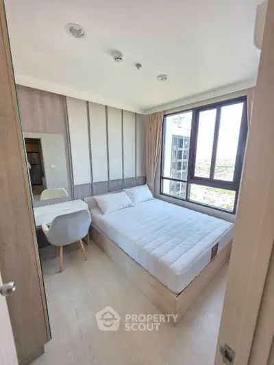 Modern bedroom with large window and stylish decor in a high-rise apartment.