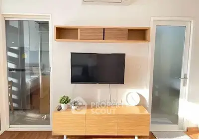 Modern living room with wall-mounted TV and sleek wooden furniture