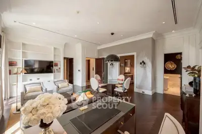 Luxurious living room with elegant decor and open layout, featuring modern furniture and ambient lighting.