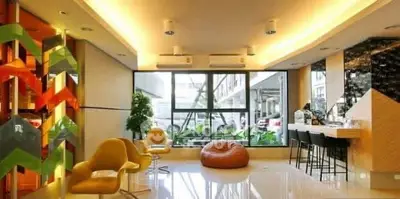 Modern living room with stylish decor and large windows offering natural light.
