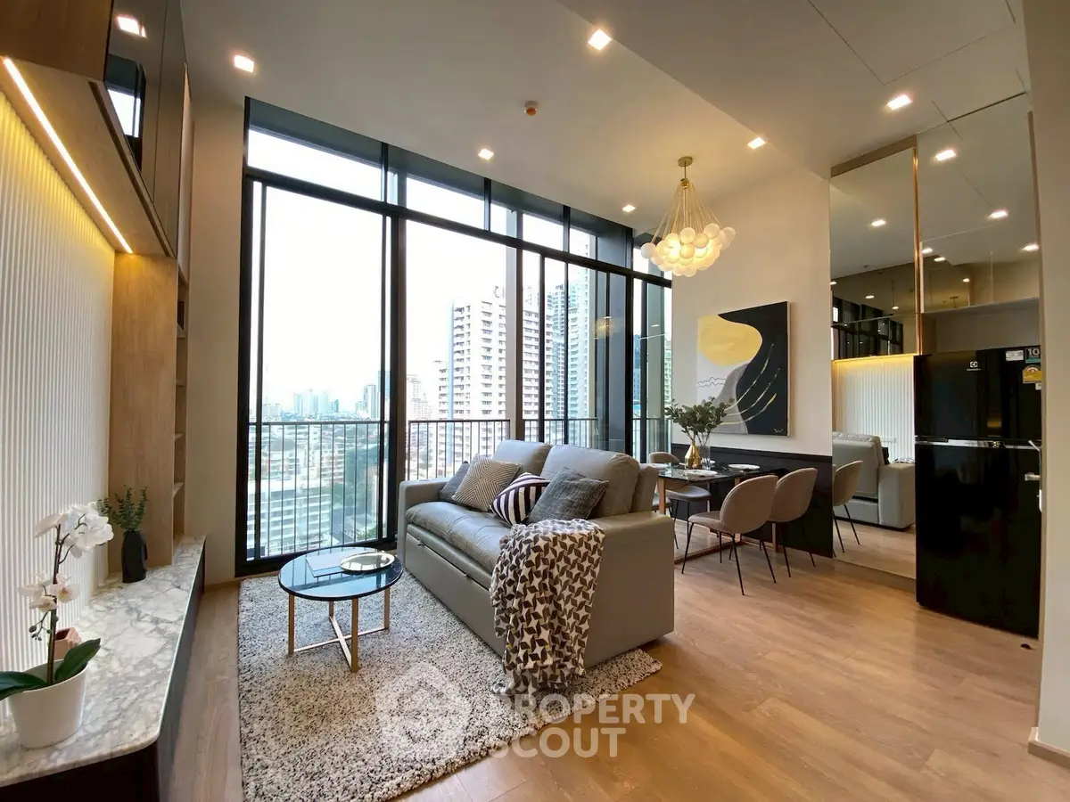 Luxurious modern living room with city view, elegant decor, and open layout.