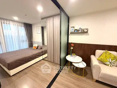 Modern bedroom with cozy seating area and stylish decor