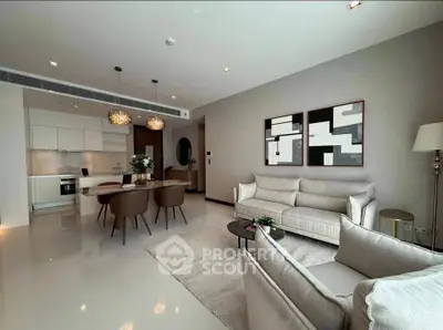 Luxurious open-plan living room with modern kitchen, elegant decor, and stylish furniture in a contemporary apartment.