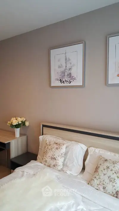 Charming bedroom with elegant decor and Paris-themed artwork, perfect for cozy living.