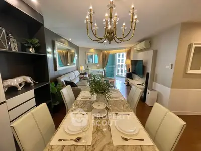 Luxurious living room with elegant dining area and chandelier, perfect for entertaining.