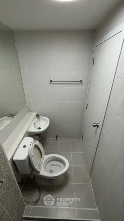 Modern bathroom with sleek white fixtures and minimalist design, perfect for contemporary living.