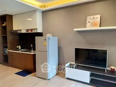 Modern kitchen and living area with sleek appliances and stylish decor.