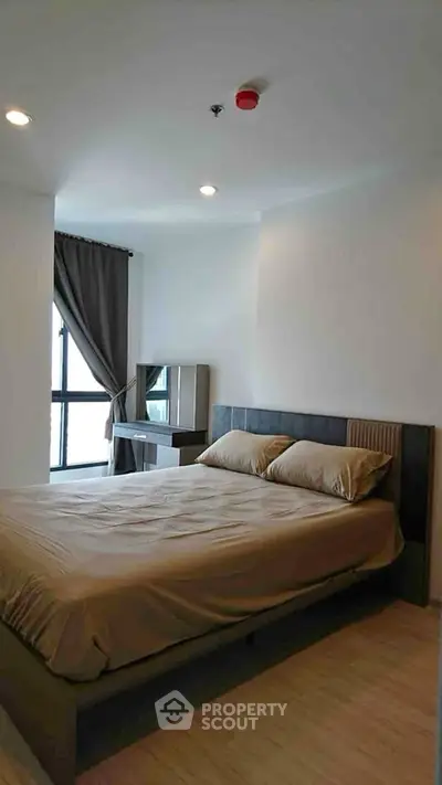 Modern bedroom with stylish decor and natural light in urban apartment