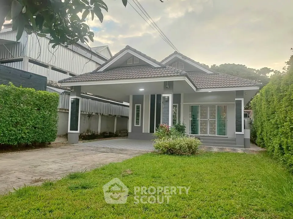 Charming single-story house with lush green lawn and modern facade