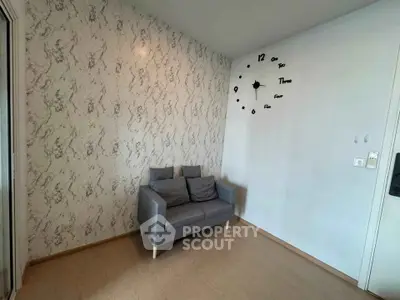 Cozy living room with stylish wall clock and modern sofa, perfect for relaxation.
