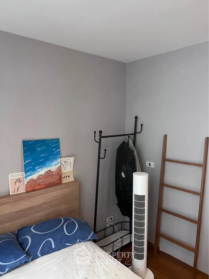 Cozy bedroom with modern decor and stylish wooden accents, perfect for relaxation and comfort.
