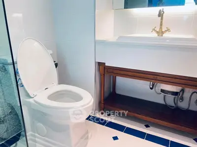 Modern bathroom with elegant fixtures and stylish tile flooring.