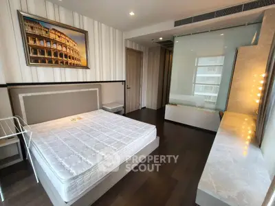 Modern bedroom with stylish decor and large window for natural light.