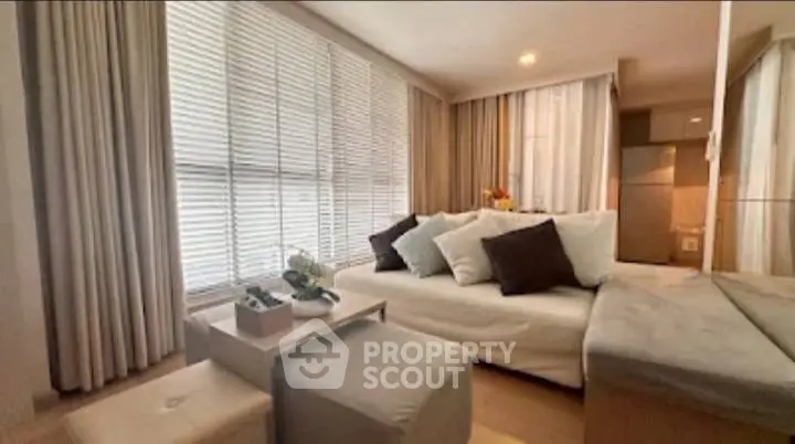 Modern living room with cozy seating and natural light, perfect for relaxation and entertaining.