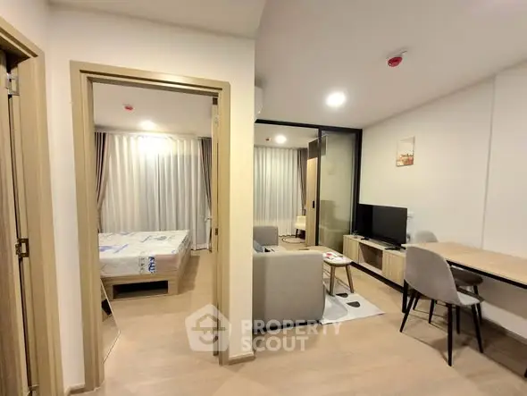 Modern apartment interior with open living room and bedroom view
