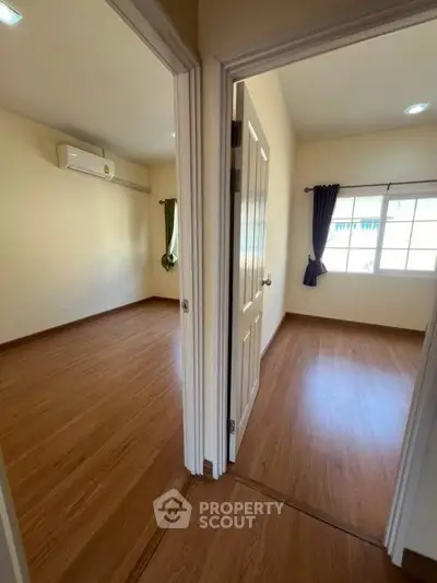 Spacious two-bedroom unit with wooden flooring and ample natural light.