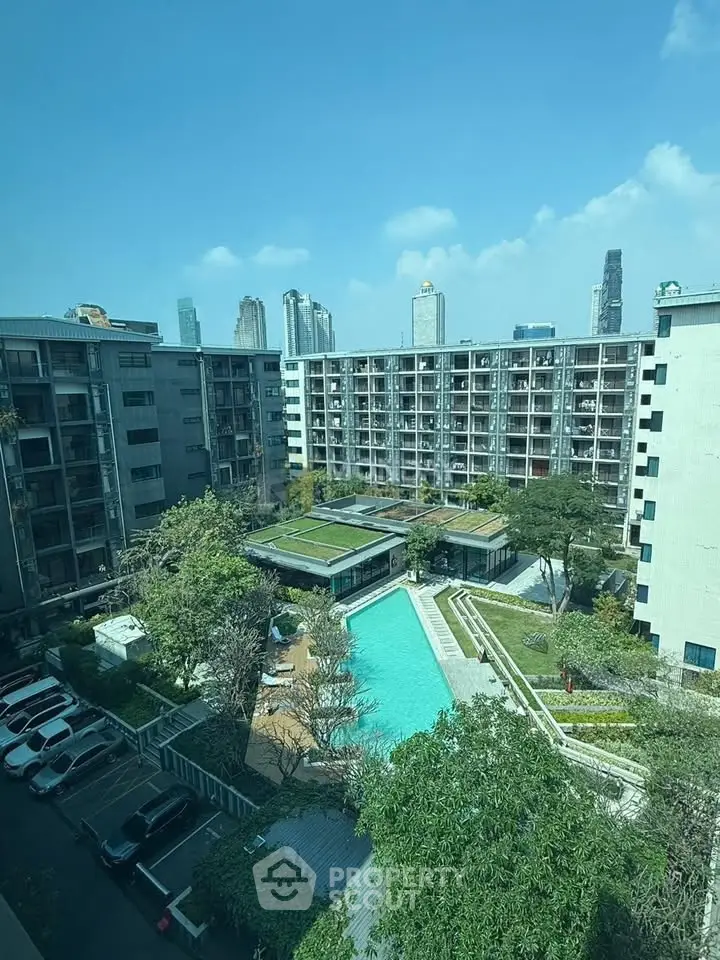 Stunning urban apartment complex with pool and skyline view, perfect for modern living.