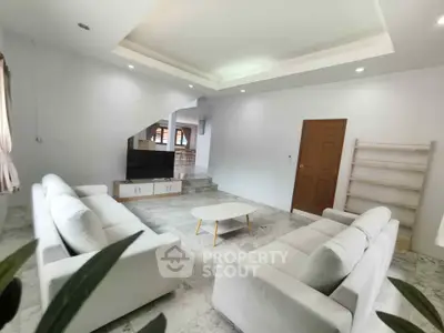 Spacious modern living room with elegant white sofas and sleek design