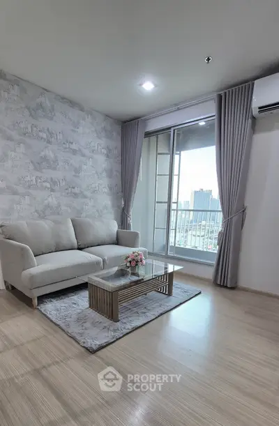Modern living room with city view, featuring elegant decor and a cozy sofa.