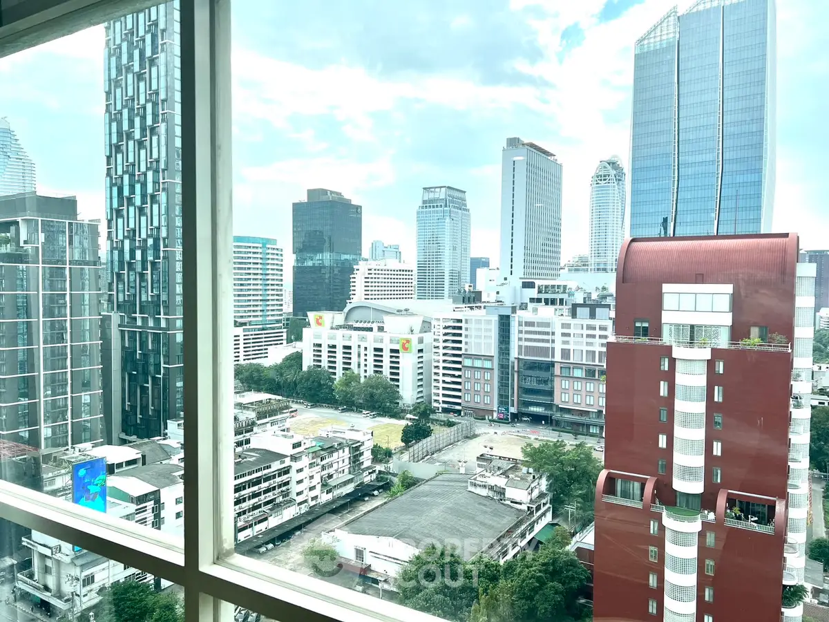 Stunning cityscape view from high-rise apartment window, showcasing modern urban skyline.