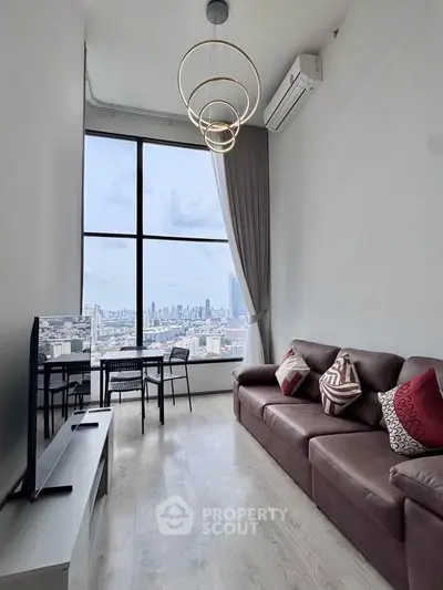 Modern living room with high ceiling and city view, featuring stylish furniture and large windows.