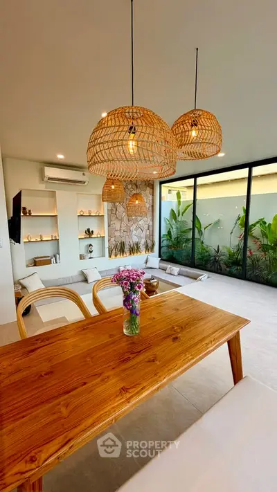 Stunning open-plan living room with modern decor and large windows overlooking a lush garden.