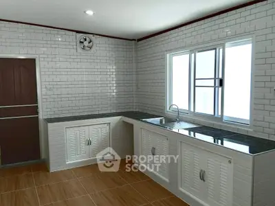 Spacious modern kitchen with sleek white cabinetry and tiled walls, featuring ample natural light and wooden flooring.