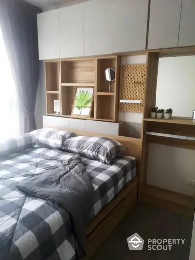 Modern bedroom with stylish decor and natural light, featuring a cozy bed and wooden shelving.