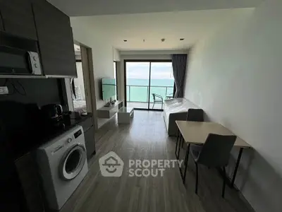 Modern beachfront apartment with open living space and stunning ocean view.
