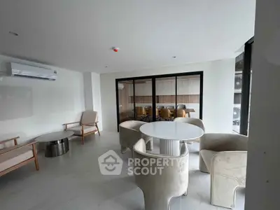 Modern living room with elegant furniture and large windows in a contemporary apartment.