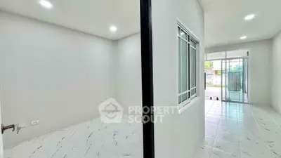 Spacious modern interior with tiled floors and bright lighting, perfect for versatile living arrangements.