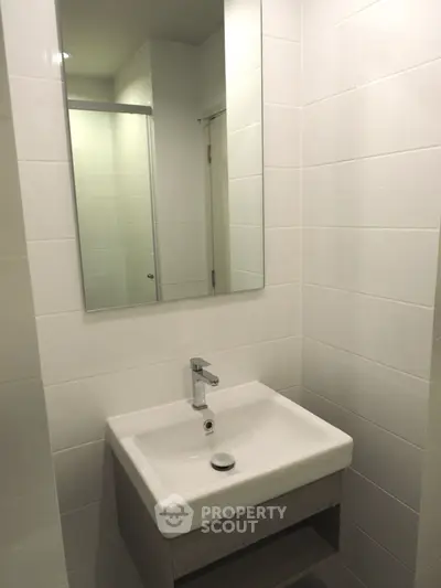 Modern bathroom with sleek sink and mirror in minimalist design