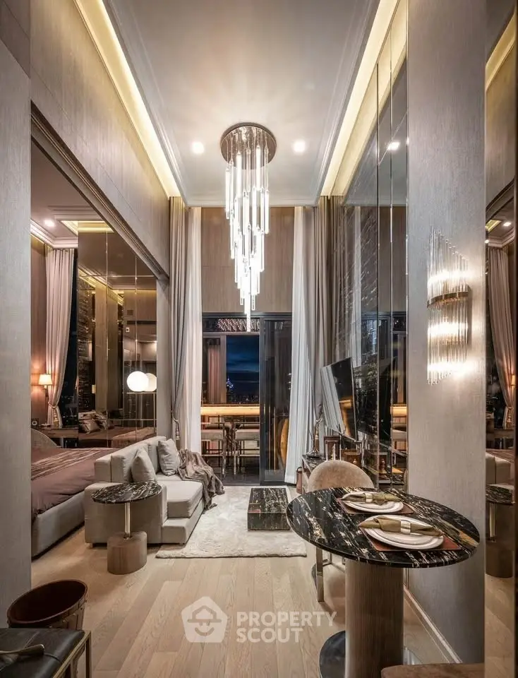 Luxurious modern living room with elegant chandelier and open balcony view.