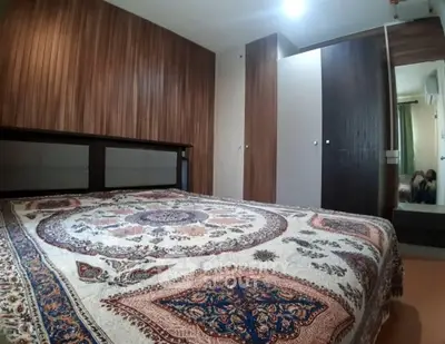 Cozy bedroom with elegant wooden paneling and patterned bedspread