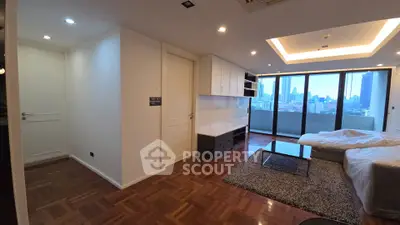 Spacious modern living room with city view and large balcony access.
