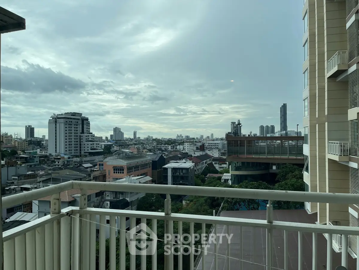 Stunning cityscape view from a high-rise balcony with modern urban skyline.