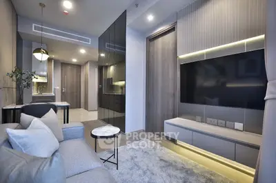 Modern living room with sleek design and large TV, perfect for relaxation.