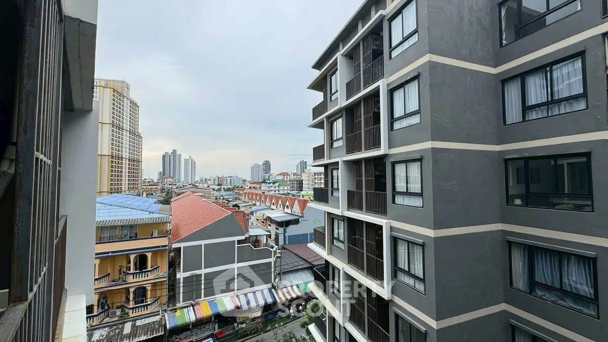 Urban apartment view showcasing city skyline and neighboring buildings.