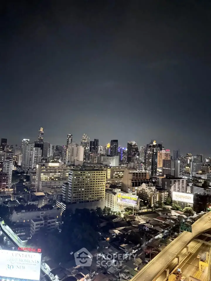 Stunning cityscape view of illuminated skyline at night, showcasing vibrant urban living.
