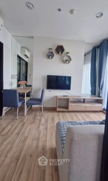 Modern living room with stylish decor and wooden flooring in a cozy apartment.